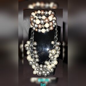 Leather strap and chain faux pearl necklace accompanied with a similar bracelet.